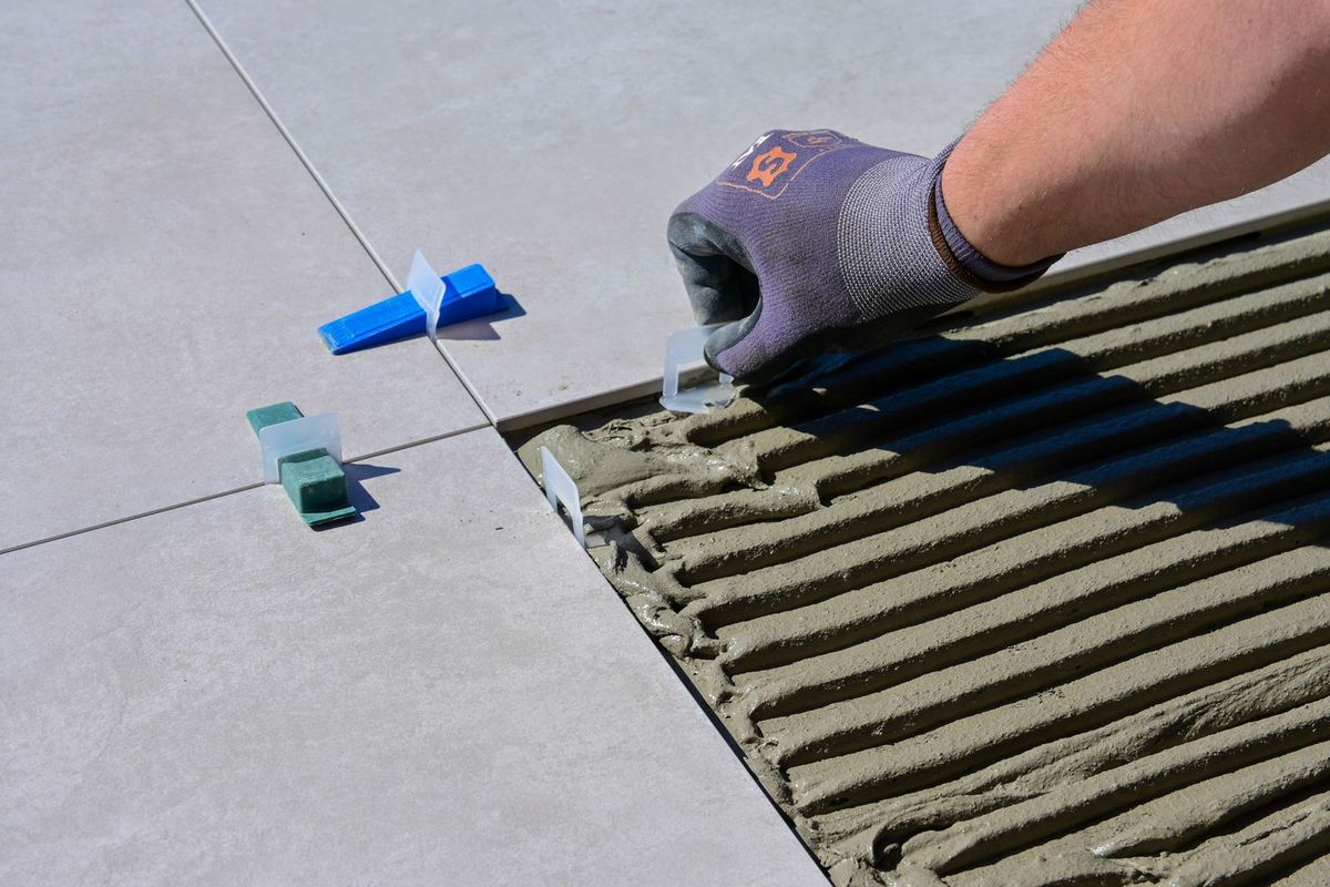 Tile being set with spacers and thinset